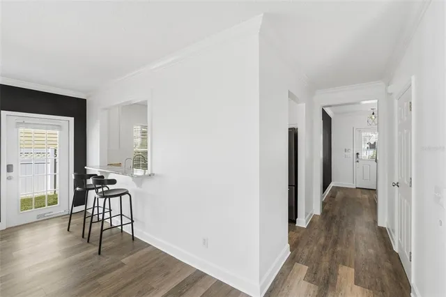 a view of an empty room with closet and a window