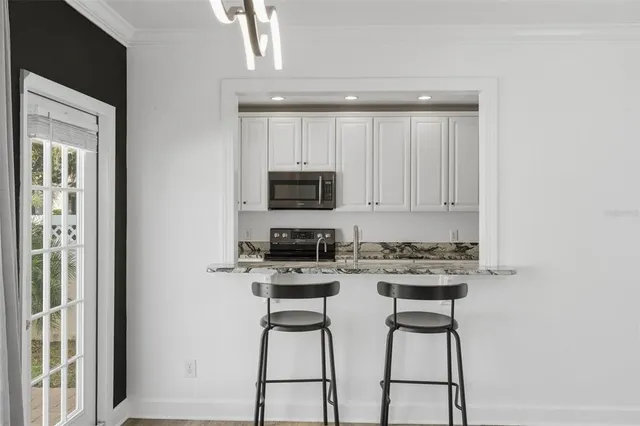 a dining room with furniture window and wooden floor