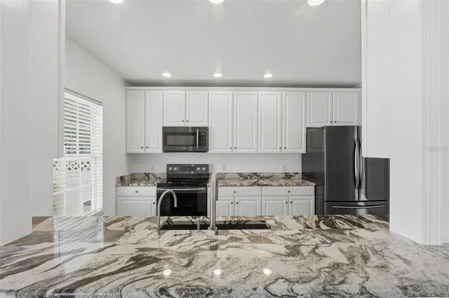 a view of a livingroom with wooden floor and a flat screen tv