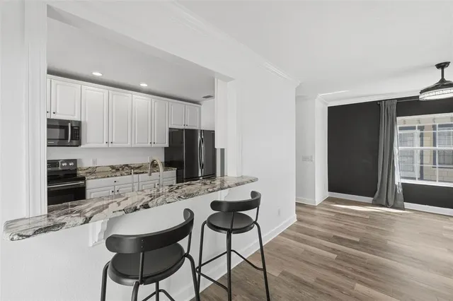 a bedroom with a large bed and a flat screen tv