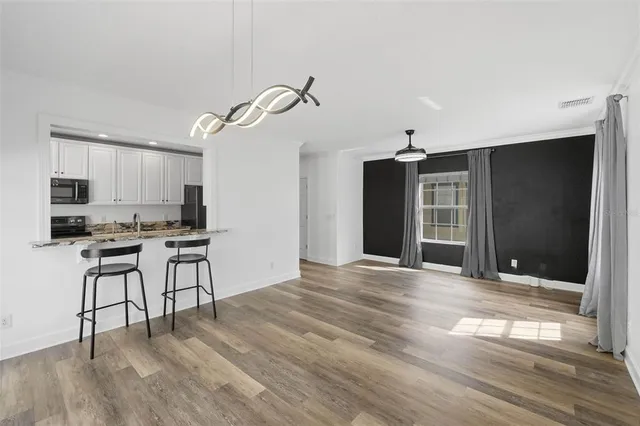 a view of livingroom with hardwood floor and a ceiling fan