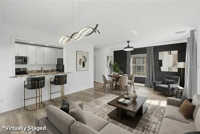 a view of a room with furniture and wooden floor