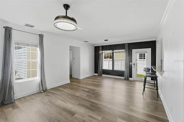 a view of a livingroom with wooden floor and a chandelier