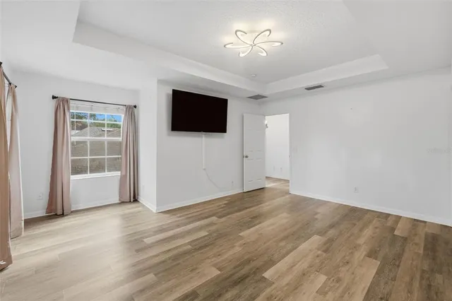 a bedroom with a bed a mirror and a window