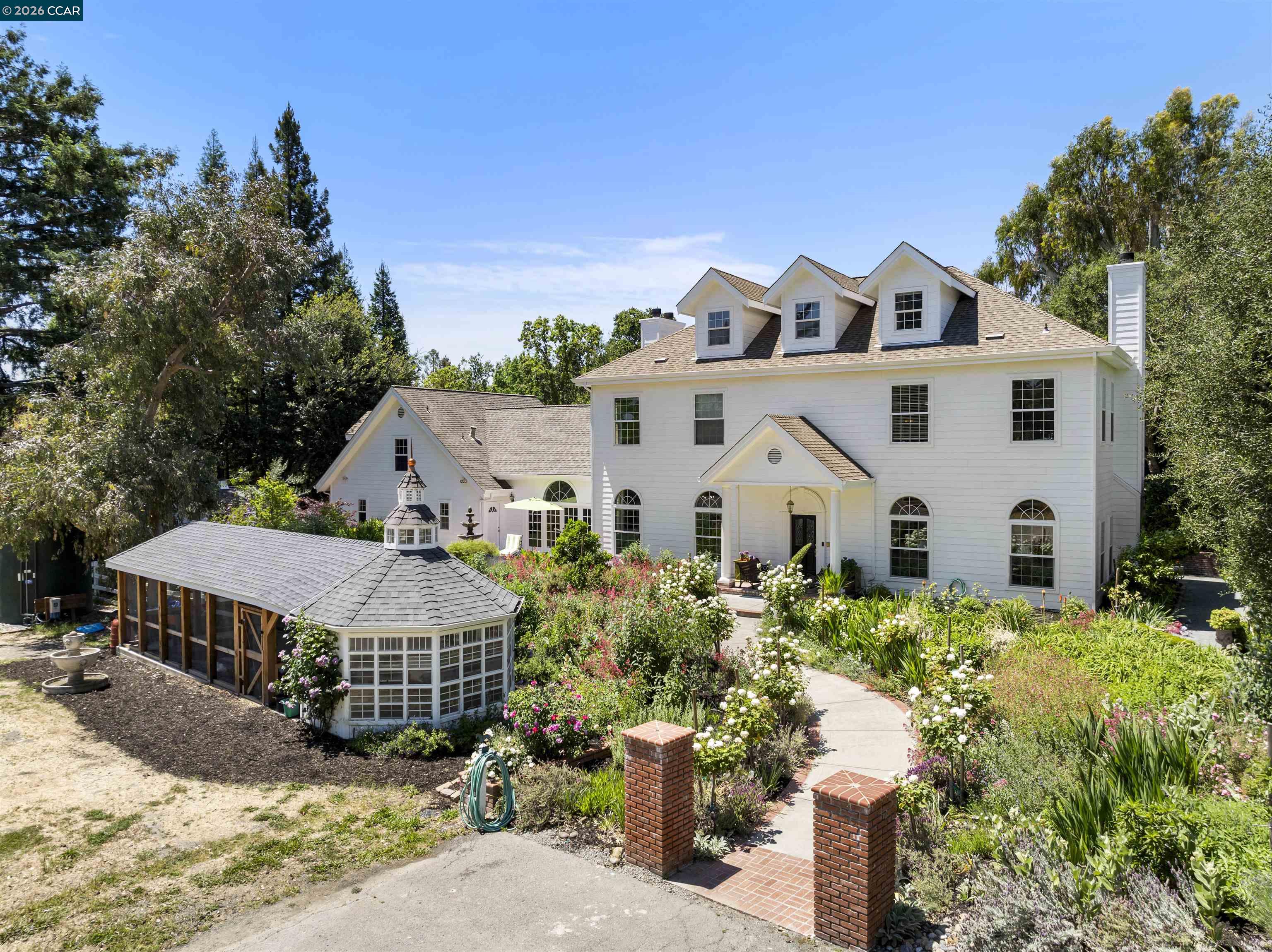 177 Oak Road Alamo, CA 94507 - Photo 2 of 85 a view of a white house with a yard plants and large tree