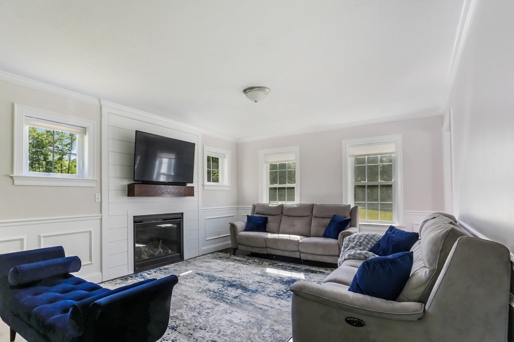 7 Station Street Kingston, MA 02364 - Photo 5 of 20 a living room with furniture a flat screen tv and a fireplace