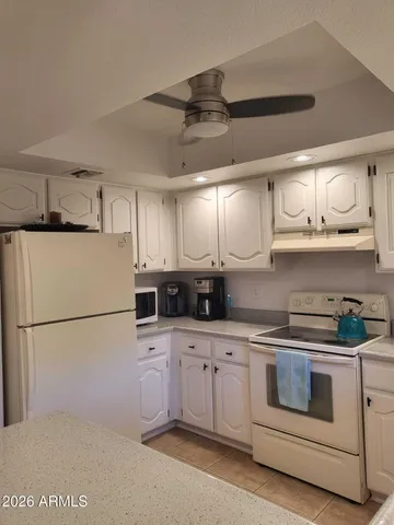 a kitchen with stainless steel appliances granite countertop a sink a stove and a refrigerator