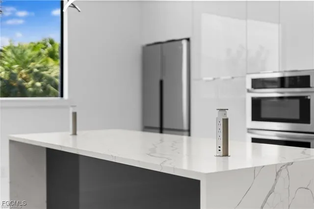 a kitchen with stainless steel appliances a refrigerator and a sink