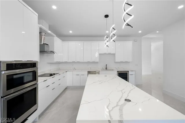 a kitchen with a stove a sink and a refrigerator