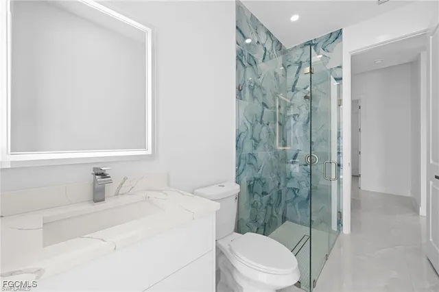 a bathroom with a shower toilet and sink