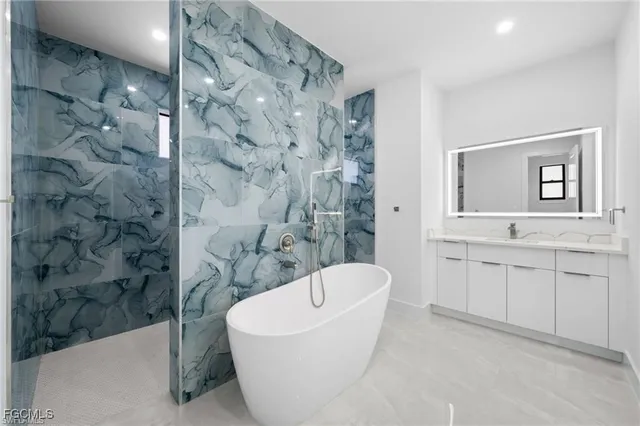 a bathroom with a granite countertop sink a toilet and bathtub