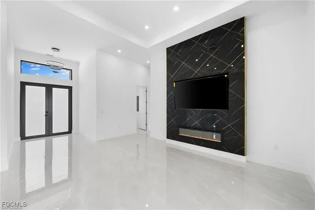 a view of an empty room with a fireplace and a window