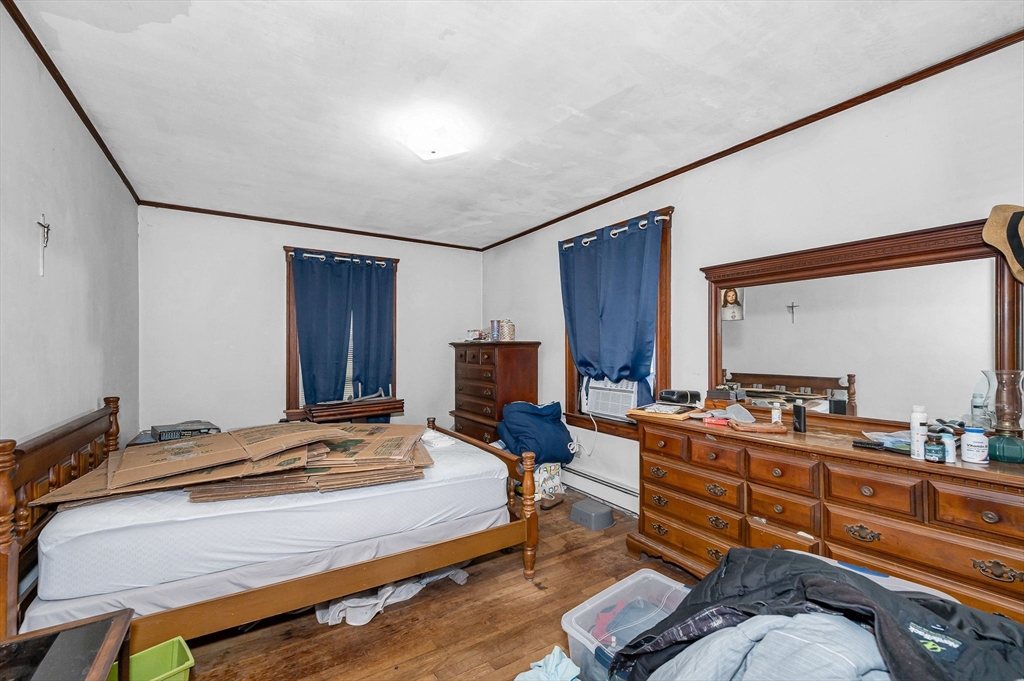 445 East Foster Street Melrose, MA 02176 - Photo 16 of 40 a bedroom with furniture and a large mirror