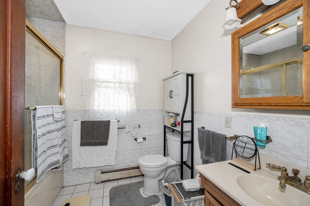 445 East Foster Street Melrose, MA 02176 - Photo 17 of 40 a bathroom with a toilet a sink and a mirror