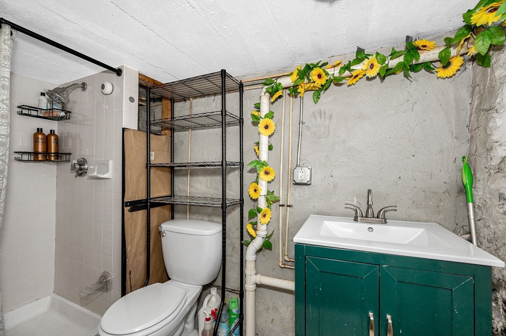 445 East Foster Street Melrose, MA 02176 - Photo 27 of 40 a bathroom with a sink toilet and shower