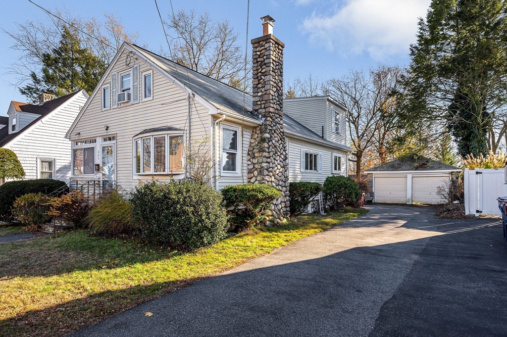 445 East Foster Street Melrose, MA 02176 - Photo 3 of 40 a front view of a house with a yard and outdoor seating