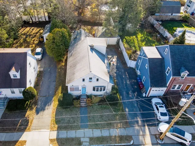 an aerial view of a house with a yard