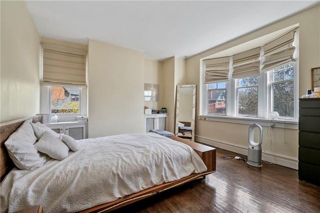 a bedroom with a large bed and a large window