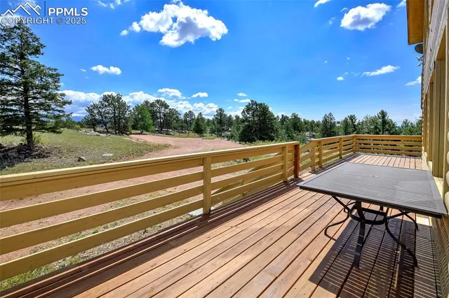 a view of a balcony with wooden floor and outdoor seating