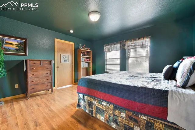 a bed sitting in a bedroom next to a window