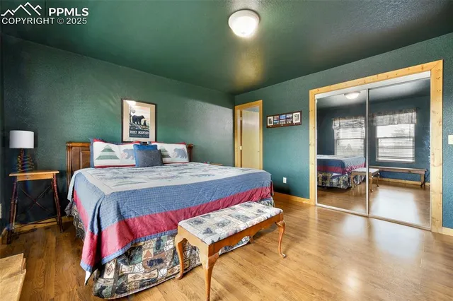 a bedroom with a bed and a large mirror