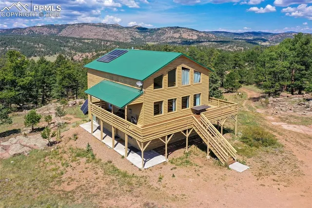 an aerial view of a house with a yard
