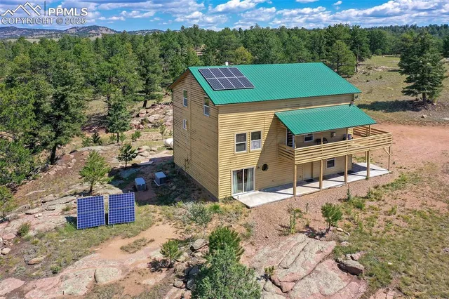 an aerial view of a house with a yard