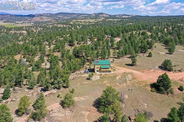 an aerial view of a house with a yard