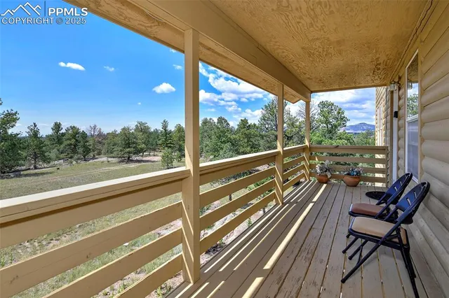 a view of two chairs in a balcony