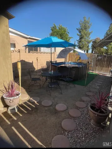 a view of a porch with furniture and a yard
