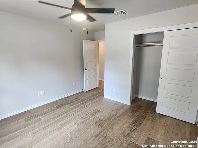 an empty room with wooden floor