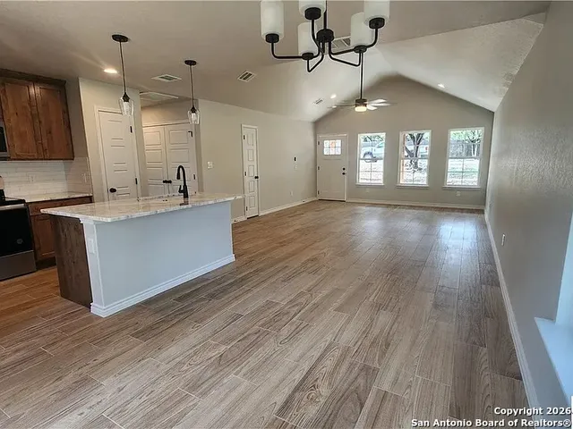 a view of a kitchen with cabinets and wooden floor