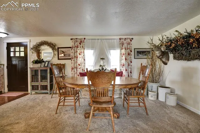 a view of a dining room with furniture and chandelier