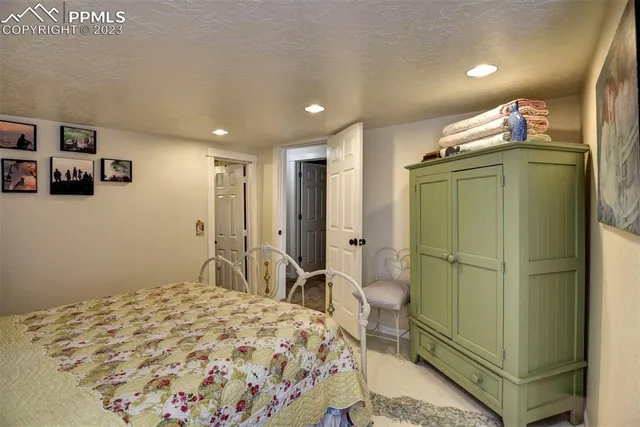 a bedroom with a bed and a refrigerator