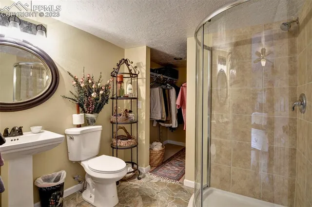 a bathroom with a toilet and a shower