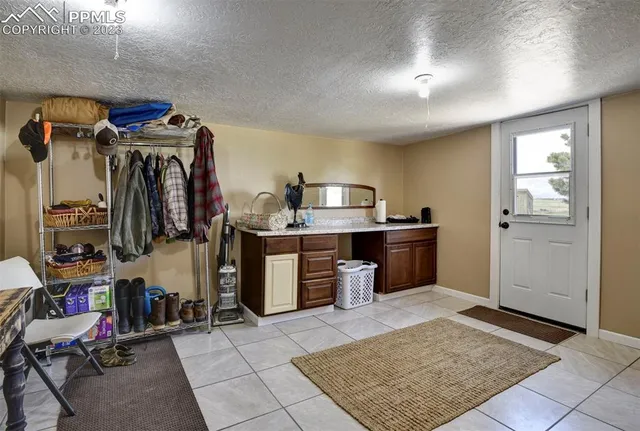 a view of backyard of house with car parked in front of it