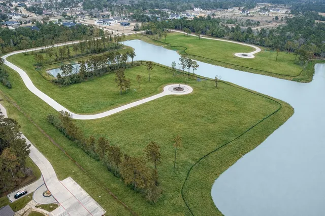 an aerial view of a golf course with a swimming pool