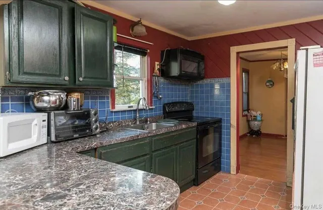 a kitchen with stainless steel appliances granite countertop a sink stove and granite counter top