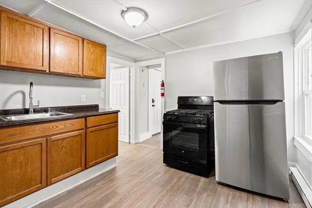 a kitchen with a refrigerator and a sink