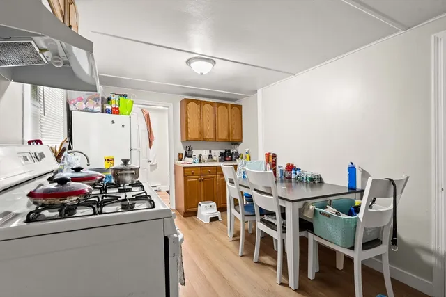 a view of a dining room with furniture a chandelier and wooden floor