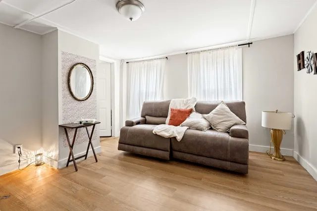 a living room with furniture a window and a chandelier