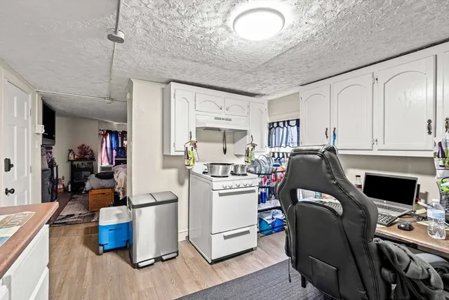 a view of a kitchen with fridge and workspace