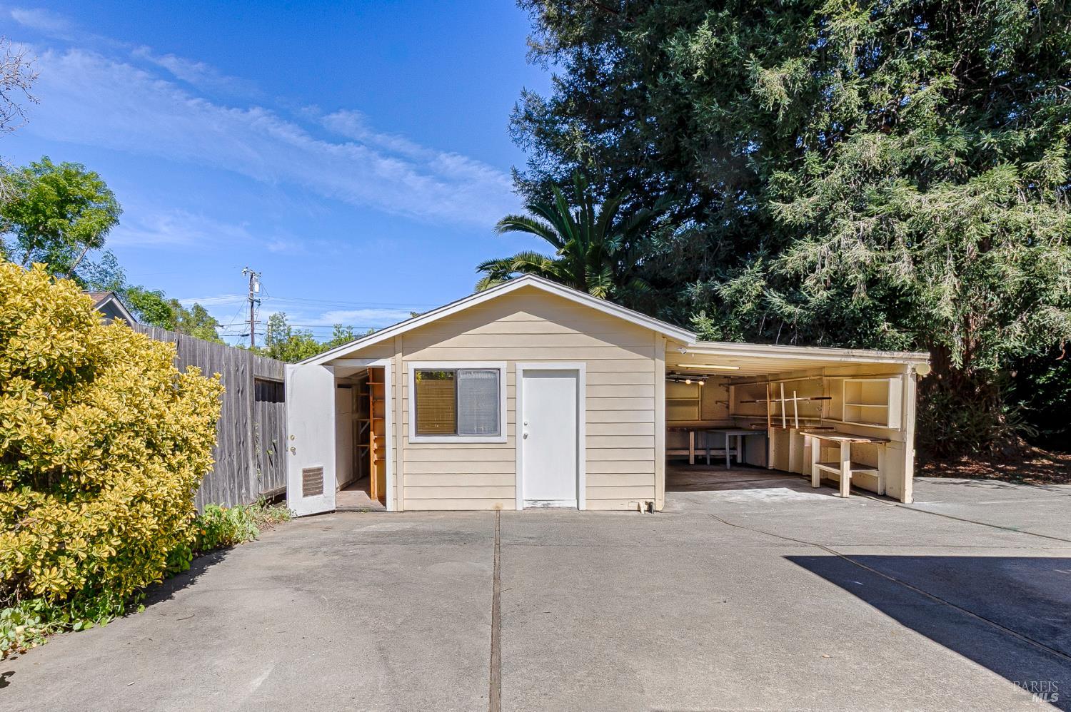 41 Meadow Avenue San Rafael, CA 94901 - Photo 36 of 55 Behind the garage is a workshop with a storage closet on the left. On the righ is a "carport". Much of the backyard is paved.