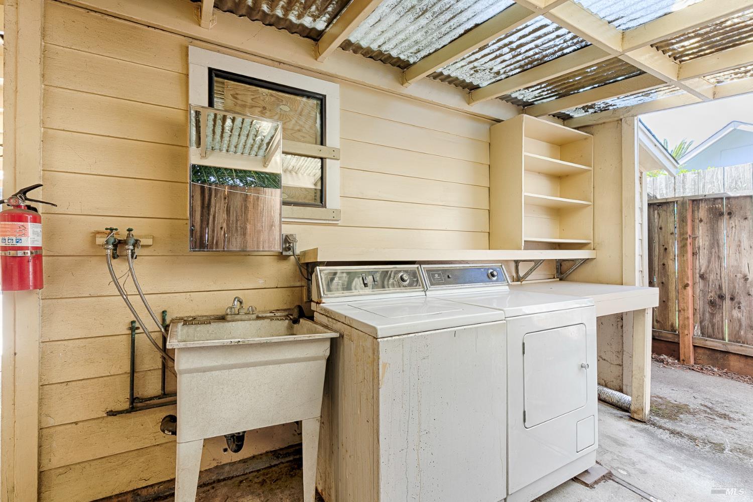 41 Meadow Avenue San Rafael, CA 94901 - Photo 47 of 55 The washer and dryer are behind the shop. Utility sink. There is a corrogated cover over the top.