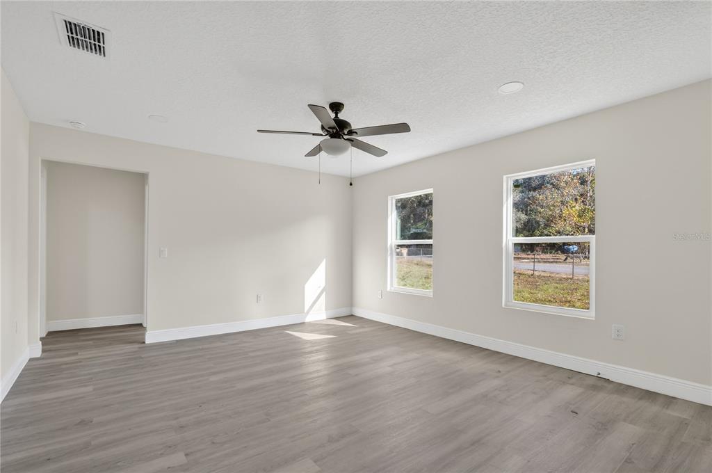 40415 Country Road Eustis, FL 32736 - Photo 12 of 39 a view of an empty room with a window and wooden floor