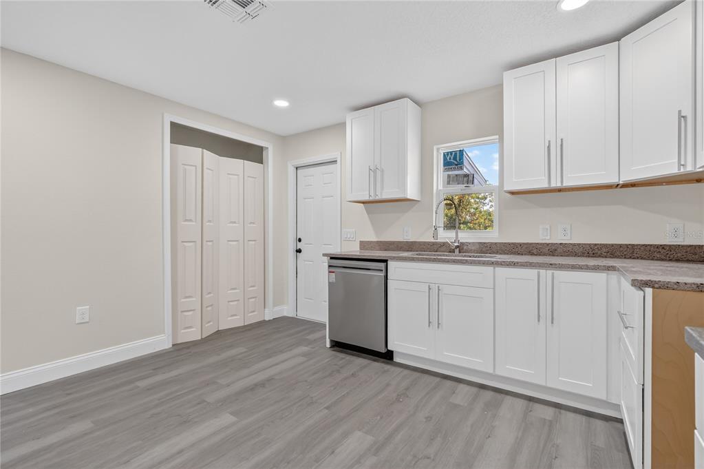40415 Country Road Eustis, FL 32736 - Photo 26 of 39 a kitchen with granite countertop white cabinets and white appliances