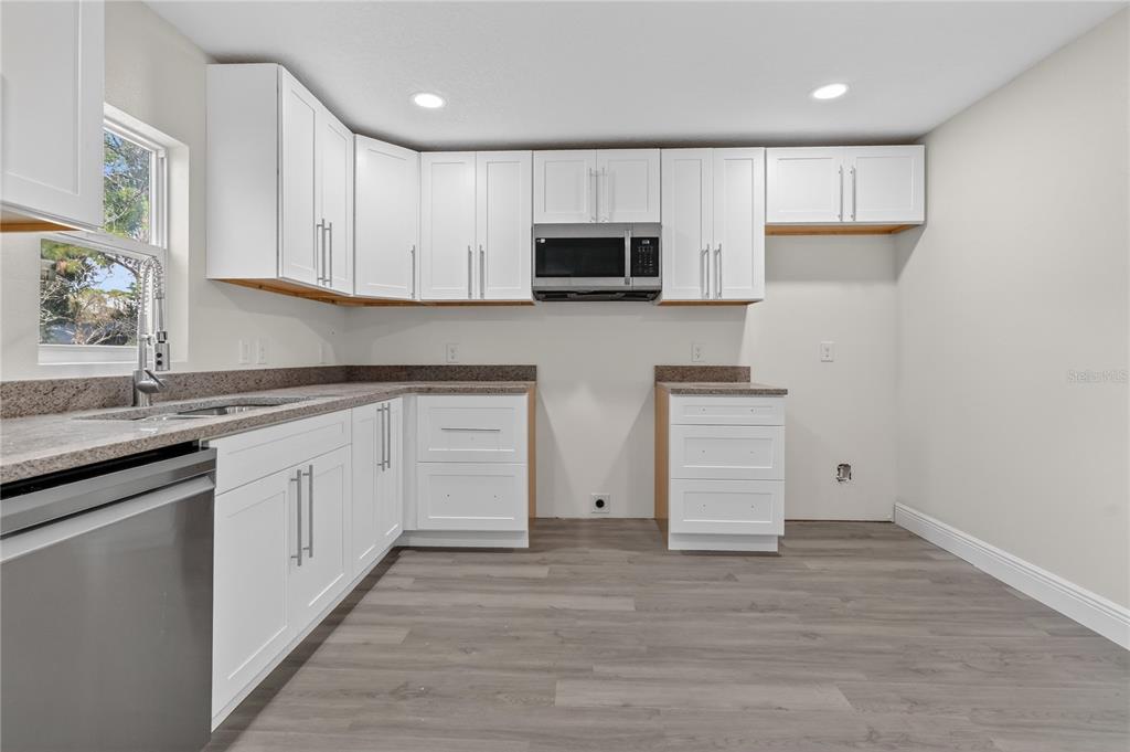 40415 Country Road Eustis, FL 32736 - Photo 27 of 39 a kitchen with white cabinets stainless steel appliances and sink