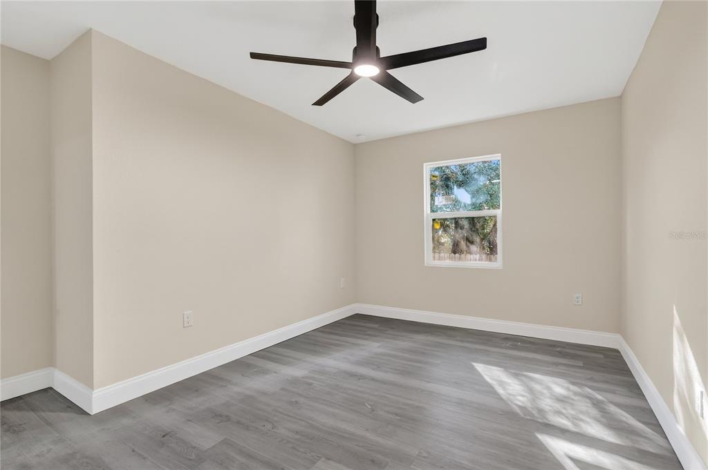 40415 Country Road Eustis, FL 32736 - Photo 32 of 39 an empty room with a window and a ceiling fan