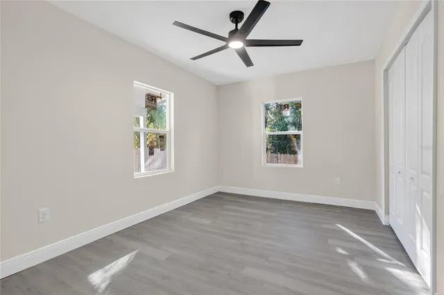 wooden floor in an empty room with a window