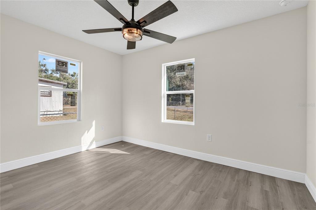 40415 Country Road Eustis, FL 32736 - Photo 36 of 39 a view of an empty room with a window and wooden floor